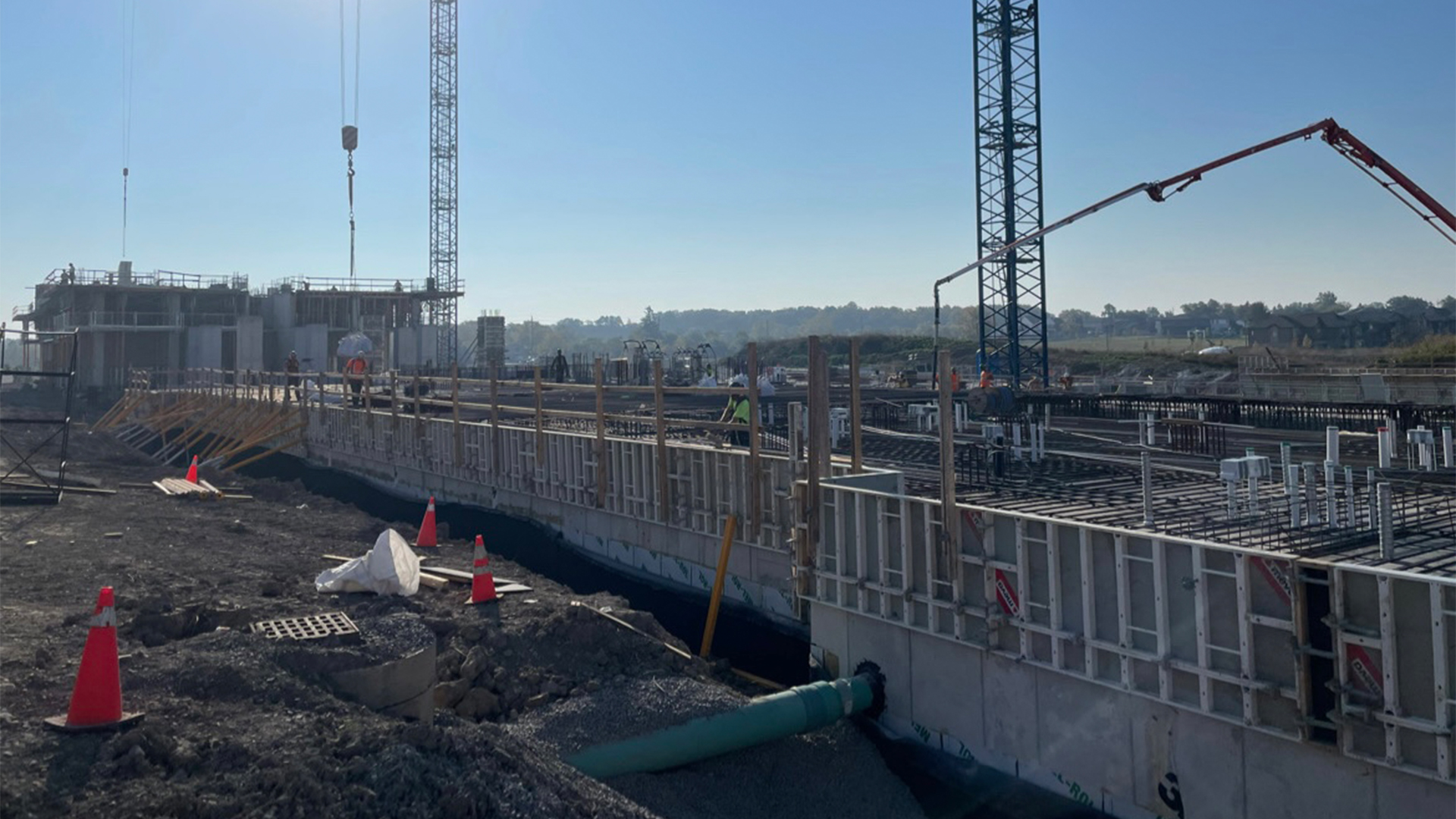 An early project photo of the construction site, where workers are laying the foundation of the SOHO Phase One project.